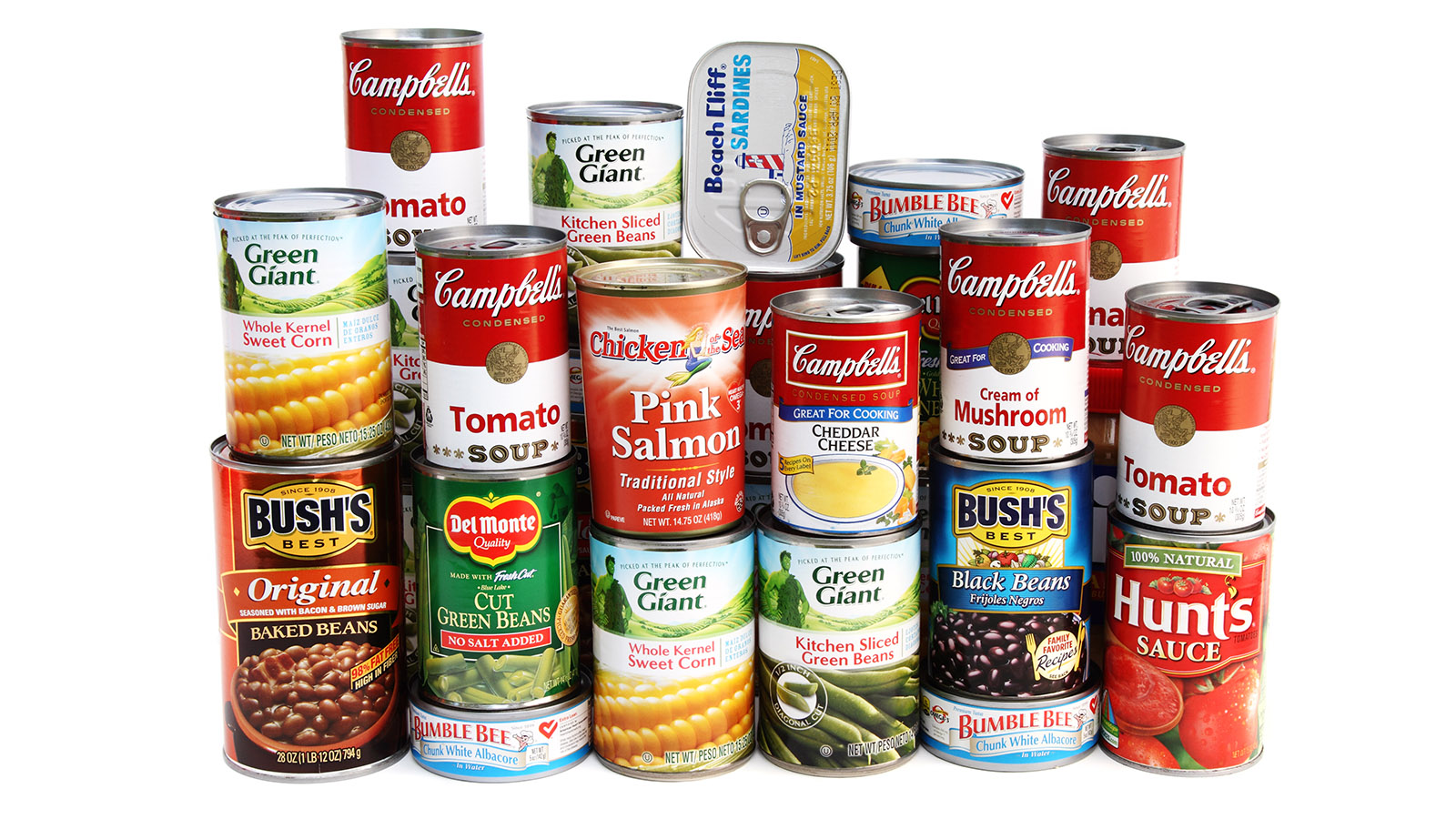 "West Palm Beach, USA - September 15, 2012:  A studio shot of a large assortment of canned foods piled  two layers high and deep. Brands include Campbell's, Bush's, Green Giant, Del Monte, Bumble Bee, Chicken of the Sea and Hunts. Foods include baked beans, black beans, green beans, tomato sauce, corn, several varieties of soup, albacore, salmon, and sardines."